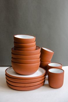 a stack of brown dishes sitting on top of each other