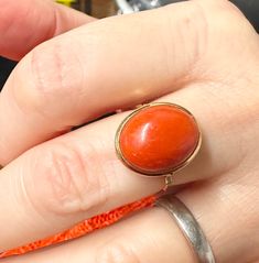 This stunning vintage ring boasts a beautiful oval shaped natural coral stone in a salmon pink colour.  It is in a rubbed over setting with a fine shank that has a small area of groove decoration.  The coral stone measures 15mm in length and 13mm in width.  The ring is a UK size N and is a unique piece as the coral is natural and unique and hand finished to creat this lovely cabachon. There is a small makers mark on the underside of the mount but I cannot work out what is says.  Other than that Vintage Coral Jewelry For Anniversary, Coral Vintage Jewelry For Anniversary, Oval Coral Jewelry For Gift, Classic Orange Oval Jewelry, Antique Orange Oval Ring, Coral Oval Jewelry For Gifts, Antique Oval Orange Jewelry, Vintage Red Oval Ring, Vintage Red Oval Rings