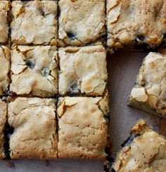 blueberry bars cut into squares on a cutting board