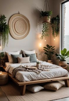 a bed with pillows, blankets and plants on the wall