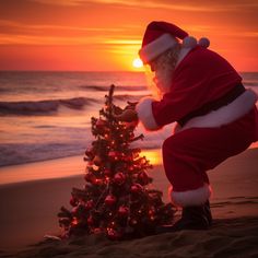 a santa clause is decorating a small christmas tree on the beach at sunset or dawn