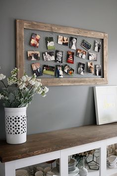 a vase with flowers sitting on top of a wooden shelf next to a white wall