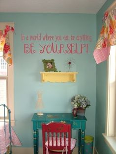 a child's room with a desk, chair and wall decal that says be yourself