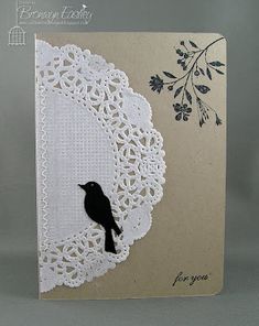 a white card with a black bird on it