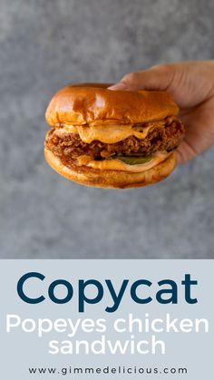 a person holding a sandwich in their hand with the caption copycat popes chicken sandwich