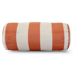 an orange and white striped pillow on a white background