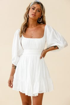 White dress  Off-shoulder style  Balloon sleeves  Gathered detailing in bust  Waist band  Tie-up back  Zipper in back   You'll be stealing hearts in our adorable Abby dress. We are obsessed with the off-shoulder style and super cute, tie-up back! Perfect for a girls' day out, getting matching manis and shopping 'til you drop. Team it with a cute head scarf, mules and a tote. Outfits Selfie, Graduation Dress College, Confirmation Dresses, White Dresses Graduation, Selfie Leslie, Off Shoulder Fashion, Grad Dresses, Popular Outfits, Back Dress