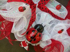 a ladybug decoration on top of white mesh with red and black polka dots