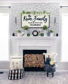 a living room filled with furniture and a sign on the wall over a fire place