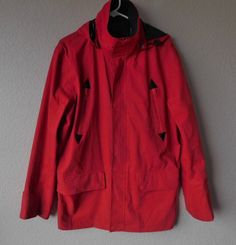 "Red raincoat with detachable hood, mock collar Zipper closure with snap buttons and draw string Two zip front pocket Two pockets with snap buttons;Two inside pockets with zipper Shell - 75% cotton, 25% polyamide; 100% polyamide lining - polyamide is water resistant fabric Was designed in France Signs of normal wear - a tiny pin-size discolored at front bottom. Hardly noticeable. Other than that, condition is great Dimension - shoulder 20\", armpit to armpit 24\", sleeve 25.5\", length 32\"" Red Raincoat, Red Rain, Red Water, Knit Men, Saint James, St James, Rain Coat, Mens Short Sleeve Shirt, Front Bottoms