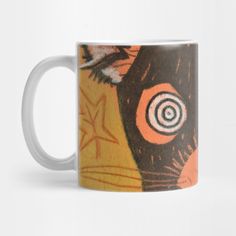 a coffee mug with an orange and black cat design on the front, sitting against a white background