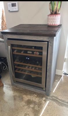 an empty wine cooler in the corner of a room