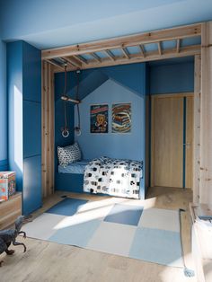 a bedroom with blue walls and wood trimmings on the ceiling is decorated in an eclectic style