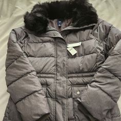 Nwt Gap Puffer Jacket With Faux Fur Removable Collar. The Color Is Like A Gunmetal Gray. This Is An Absolutely Gorgeous Winter Jacket. Has Two Front Pockets And Pockets On Each Side. Cinching Around The Bottom Of Sleeves To Keep You Warm. The Length Is 27 Inches. Size Small But Very Roomy. Gap Hooded Fall Outerwear, Gap Hooded Outerwear For Fall, Fitted Gap Outerwear For Winter, Gap Winter Outerwear For Cold Weather, Gap Outerwear For Cold Weather, Hooded Outerwear With Pockets By Gap, Silver Puffer Jacket, Gap Puffer, Women's Puffer Coats