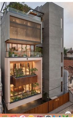 an apartment building with plants growing on the balconies and in the upper floor