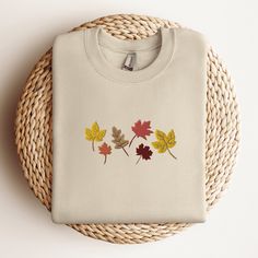 Fall Leaves Sweatshirt, Embroidered Autumn Crewneck Sweatshirt, Embroidered Leaves Shirt, Fall Season Sweatshirt, Thanksgiving Sweater This embroidered fall crewneck sweatshirt is everything. Perfect to celebrate the fall season! Please let me know if you would like extended sizing (3X-5X), I have certain color and size options available! ✨ 50% cotton, 50% polyester ✨ Pre-shrunk ✨ Classic fit Care: Machine wash: warm (max 40C or 105F) Tumble dry: low Do not iron directly on the design REFUNDS AND EXCHANGES All items are made to order using multiple suppliers to ensure quick worldwide shipping. For this reason we are unable to accept returns/exchanges unless there's a defect in the item you've received. Thank you so much for shopping! Please send me a message if you have any questions, conc Long Sleeve T-shirt With Multicolor Embroidery, Fall Embroidered Crew Top, Crew Neck Top With Custom Embroidery For Fall, Fall Crew Neck Sweatshirt With Machine Embroidery, Fall Long Sleeve T-shirt With Machine Embroidery, Fall Multicolor Embroidered Logo Tops, Long Sleeve T-shirt With Machine Embroidery For Fall, Fall Tops With Multicolor Embroidery And Logo, Multicolor Embroidered Logo Tops For Fall