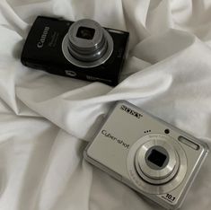 a digital camera sitting on top of a bed