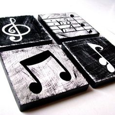 four wooden coasters with musical notes and treble clefs painted on them