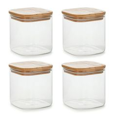 four glass jars with wooden lids are shown in three different sizes and shapes, one is empty