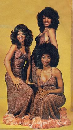 three women in brown dresses are posing for a photo on the cover of a magazine