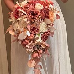 a bride holding a bouquet of flowers in her hands