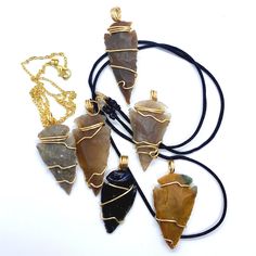 Our Gold Wire Wrapped Stone Arrowhead Pendant Necklace is a symbol of strength and protection. Native American Indians wore Arrowhead Pendant Necklaces to keep them protected against negative energy and sickness.  With an arrowhead pendant on your neck, you are protected and guarded as you journey through life. Our Gold Wire Wrapped Stone Arrowheads come in all different sizes and pictures on  display describe the general design of our Arrowheads. Disclaimer!! Do not wear your Wire Wrapped Crystals/Gemstones Jewelry in the Shower, Working Out or to Bed. Keep stones away from chemicals. Treat your Wire Wrapped Crystal/Gemstone jewelry with the utmost care for longevity. All of my Wire Wrapped Crystals/Gemstones have been cleansed and charged. This is done to ensure that any negative energie Nickel Free Arrowhead Necklace For Gift, Nickel-free Arrowhead Necklace Gift, Nickel-free Arrowhead Necklace For Gift, Spiritual Arrowhead Necklace Gift, Handmade Spiritual Arrowhead Necklace, Adjustable Arrowhead Necklace Gift, Arrowhead Wire Wrapped Necklaces For Gifts, Adjustable Wire Wrapped Arrowhead Necklace, Wire Wrapped Arrowhead Necklace For Gift