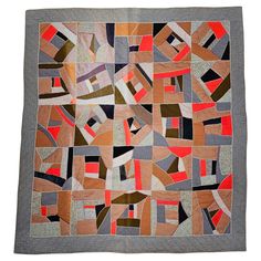 a patchwork quilt is displayed on a white surface