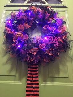 a wreath with purple and black decorations on it