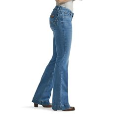 THE TROUSER: THE ULTIMATE IN WOMEN'S RETRO® JEANS Like all Wrangler Retro® jeans, our Mae wide leg is marked by its Western authenticity, making it a go-to style for cowgirls everywhere. With its contour waist and mid rise, these women's trouser jeans are made to fit comfortably while they flatter. Want the look of a flare with added comfort? Our women's wide leg jeans make it happen. With more room at the knee and a gradual opening down the leg, the Mae wide leg gives you the room you need to stay active and in style. Wrangler® jeans for women are designed with a Western state of mind, so you can be confident that they'll keep up with you no matter what the day brings. Fit: Regular Rise: Mid Front Rise: 8 5/8" Leg: Wide Leg Opening: 20 1/2" Front Closure: Zip-Fly with button closure Back Womens Trouser Jeans, Cowgirl Jeans, Retro Jeans, Stay Active, Retro Women, Wrangler Jeans, Trouser Jeans, Wide Leg Jeans, Flare Jeans