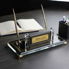 a desk with an open book and pen holder