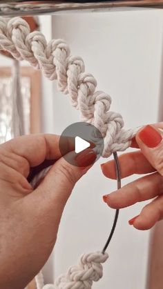 two hands are holding a piece of rope