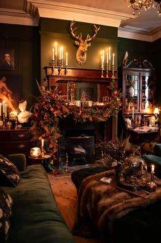 a living room filled with lots of furniture next to a fire place covered in candles