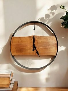 a clock that is on the side of a wall next to a potted plant