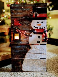 a wooden block with a snowman on it