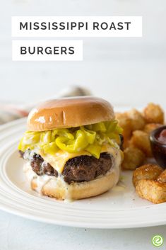 a white plate topped with a cheeseburger and tater tots next to fries