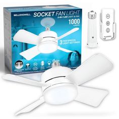 a white ceiling fan and remote control in front of a box with the package on it