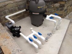 pipes are lined up on the ground next to a trash can and water pumper