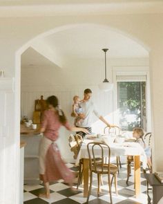 a family is gathered around the kitchen table