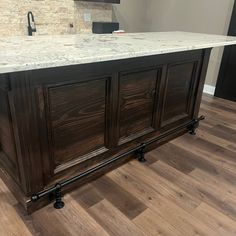 a kitchen island with marble top and metal legs