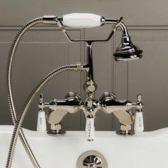 the faucet is attached to the bathtub with two handset hoses