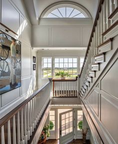 an open staircase leading up to the second floor in a house with white walls and wood trimmings