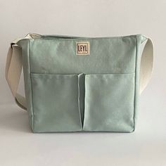 "Handmade cotton canvas tote bag with zipper that I specially designed for everyday use. Check out my tote bags for the very best in unique or custom, handmade from women's bags shop. If you want to see a different style, take a look at my collection ⬇ https://etsy.me/3fgNzR9 🎁 WHAT IS IN THE PACKAGE * 1 piece Large tote bag with zipper closure Usage: Shoulder Bag and Crossbody Bag Gender: Unisex In summary; Total pockets: 9 pockets and 2 pen holders BODY *  Cotton Canvas. The fabric has stain-proof and water-repellent properties with OEKO-TEX Standard 100 certified. (It is not completely waterproof, however.) *  Zip closure and cover * BODY FRONT:  2 pockets * BODY BACK:  1 large pocket * Fixed and adjustable canvas strap INTERIOR  *  100% cotton lining *  SIDE: 2 small pocket *  INTERIO Tote Bag With Compartments, Bag With Compartments, Planner Pouch, Tote Bag With Zipper, Teacher Tote Bag, Teacher Tote, Fabric Tote Bags, Bag With Zipper, Crossbody Tote Bag