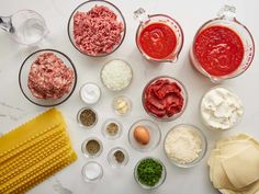 an assortment of ingredients are shown in bowls on a counter top, including eggs, cheese and sauces