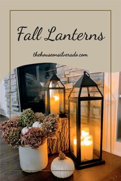 two lanterns sitting on top of a wooden table next to flowers and pumpkins with text overlay that reads, fall lanterns