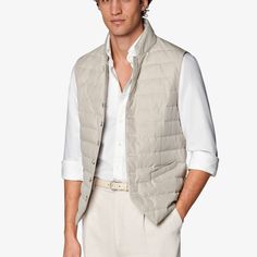 As an in-between layer or over a shirt, this sand padded vest is a versatile, trans-seasonal layering piece that effortlessly adds depth and casual appeal to any look. Classic Sleeveless Solid Outerwear, Casual Business Vest For Spring, Casual Business Casual Vest For Spring, Classic White Vest For Layering, Casual Winter Vest For Business Casual, Sleeveless Nylon Vest For Work, Winter Business Casual Vest, Casual Business Winter Vest, Elegant Beige Vest For Layering