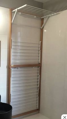 a bathroom with a shower, toilet and sink in it's corner area next to a mirror