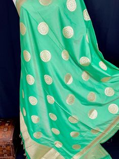 Beautiful Green Color Handmade Dupatta with Chakra design and floral design on the borders. Super Light weight and very easy to carry. Can be worn with a Suit or lehenga easily. Item: DupattaBase color : Light Green Color Zari Work : Gold Fabric : Premium quality Banarasi Soft Silk (Non-Pure)Work : Zari Weaved with tasselsLength of the dupatta : 92 inches Width of the dupatta : 37 inches Store Policies - No return or exchange will be accepted for color variations. - No return or exchange will be Green Anarkali Set With Motifs For Eid, Green Anarkali Set With Motifs, Green Bollywood Choli With Motifs, Pista Green Self Design Lehenga For Puja, Green Sharara With Motifs For Eid, Bollywood Green Choli With Motifs, Eid Green Choli With Motifs, Eid Green Sharara With Motifs, Eid Green Motifs Choli