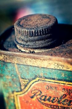 an old rusty can with a cap on top