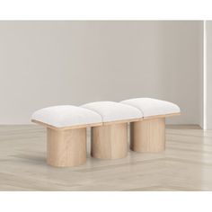 three stools sitting on top of a hard wood floor next to a white wall