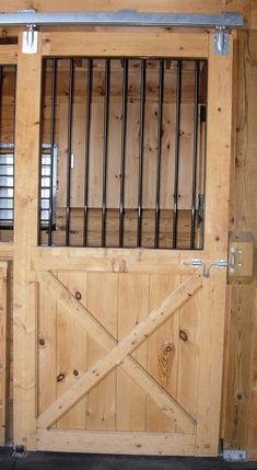 an open wooden door with bars on it